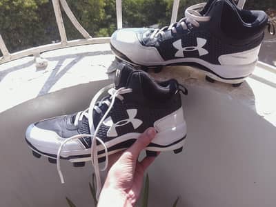 Under Armour Heater Mid TPU baseball cleats in black and white