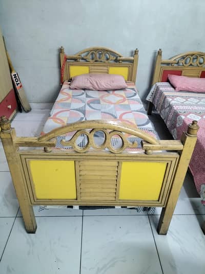 two single beds wooden