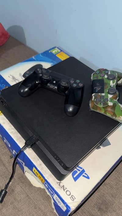 PS4 Slim with Box, 2 controllers and 2 Games. Read Ad.