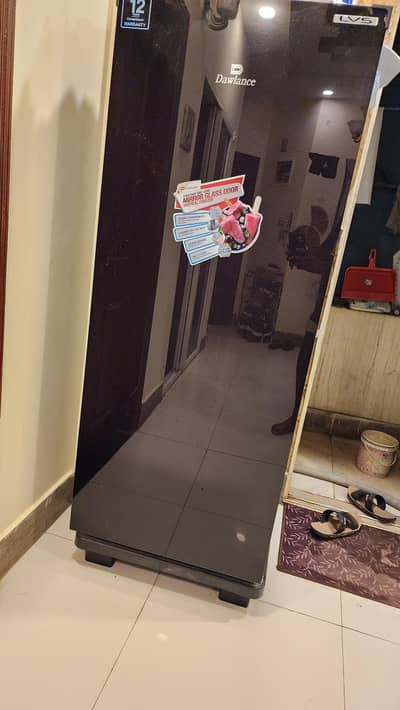 Dawlance LVS vertical freezer with a black mirror glass door.