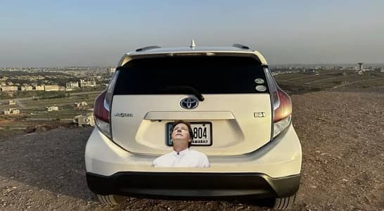 Toyota Aqua with golden number