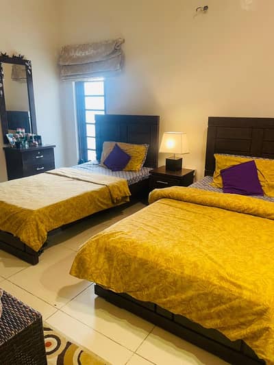 2 single beds with side table and dressing