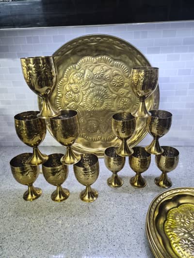 Golden polished steel glasses,plates and thaal