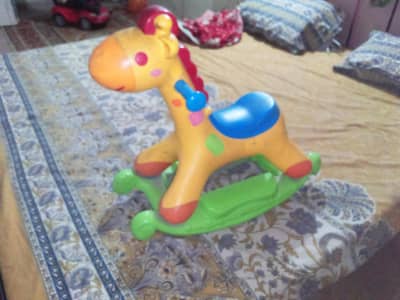 Rocking and riding giraffe swing with music