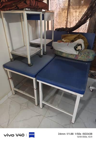 Blue clinic Examination beds, white trolleys, screens , IV stands,read