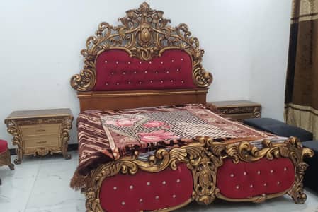 king size wooden bed with tables and dressing