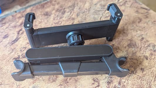 universal car headrest mount for a mobile phone or tablet.