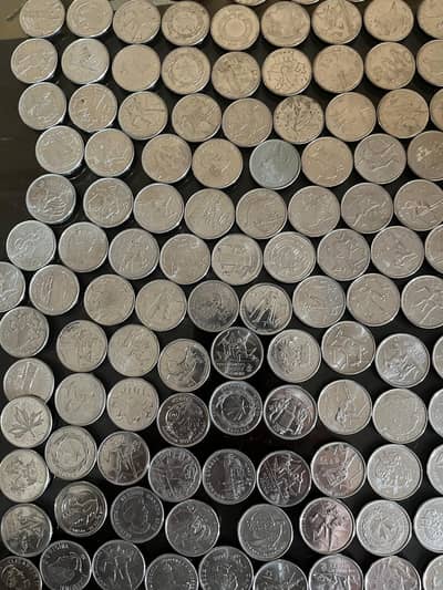 Canadian 8 Rupees and 55 rupees comimortave coins below