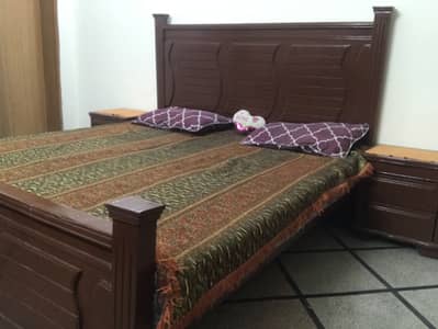 Original wooden bed with side tables and dressing table