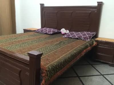 Wooden Bed With Cupboard and Two Chairs