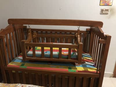 Baby bed with swing and a drawer