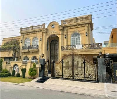 Exquisite 1 Kanal Luxury Villa for Sale in Wapda Town, Lahore!  Location: Heart of Wapda Town (Phase 1) Road: Wide 40 Feet Carpeted Road Key Features: Size: 1 Kanal (Brand New) Accommodations: 6 Spacious Master Bedrooms (Ideal for large families) Bathrooms: 7 Designer Bathrooms with high-end vanities & fittings Interiors: 2 Elegant TV Lounges, Drawing Room, & Dining Area Kitchen: 2 Fully Equipped Italian Design Kitchens Exterior: Stunning Front Elevation, Lush L