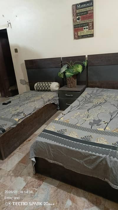 2 single beds with 4 door cupboard