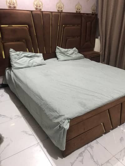 king size wooden bed with dressing table and side table