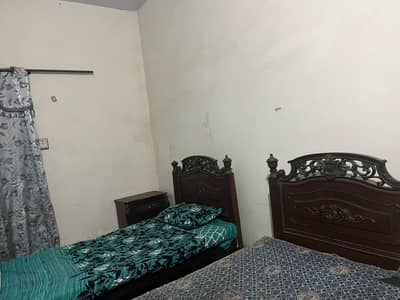2 single beds with 1 side table in good condition