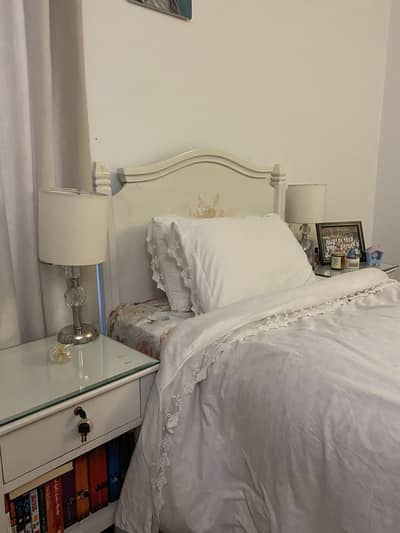 Bed with side tables and lamps