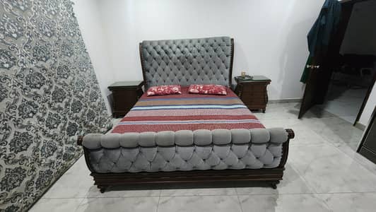 King size bed with two side lockers and dressing table