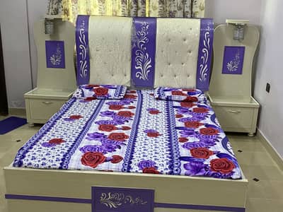 A king size bed with two side tables and dressing and 3 door wordrop