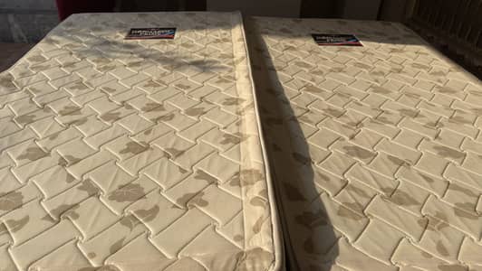 Two single hard-foam medicated mattresses