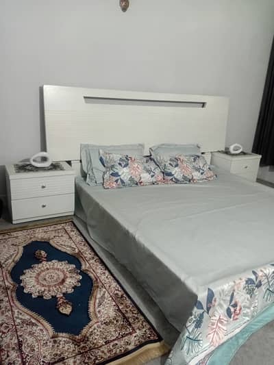 Master bed with side tables and dressor.