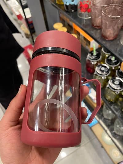 Portable Glass Water Bottle with Silicone Sleeve and Handle.