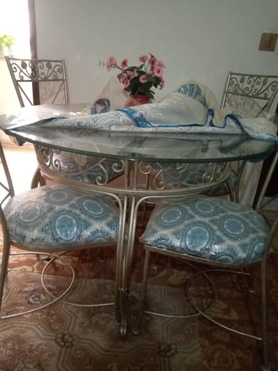 top glass rod iron table with four chairs solid