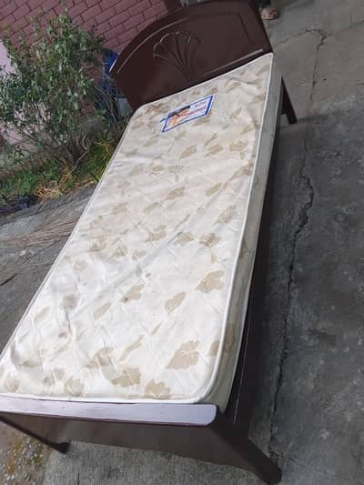 two  wooden single beds with matress
