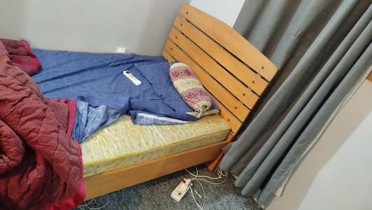 wooden almari and bed with metrsess