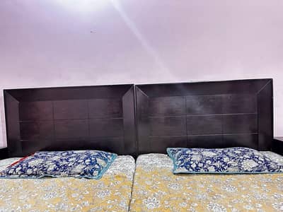 two single beds with side tables well maintained