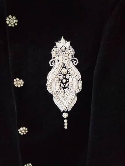 just like new black velvet sherwani with white pajama.