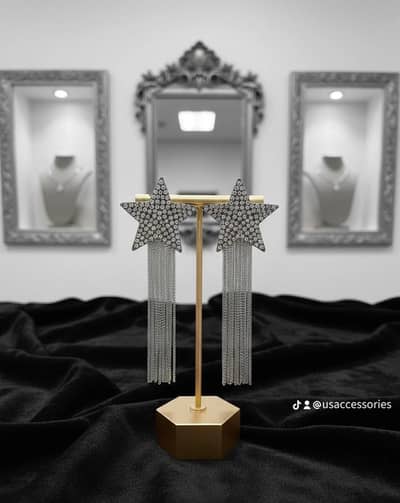 Rhinestone-studded star cascade dangle earrings.