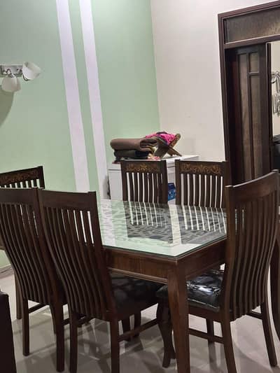 wooden dining table with 6 wooden chairs