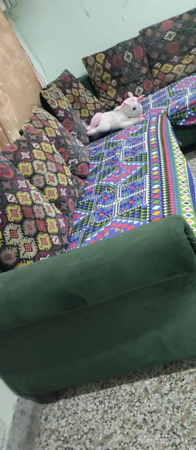 L shape bottle green 7 seater sofa set with a puffy