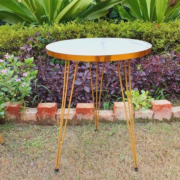 A refined wooden marble texture table framed in sleek metal, blending natural warmth, stone-like elegance, and modern industrial geometry.