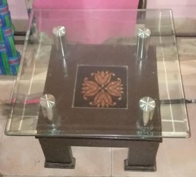Center table in wooden. with glass top