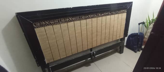 wooden bed with side table