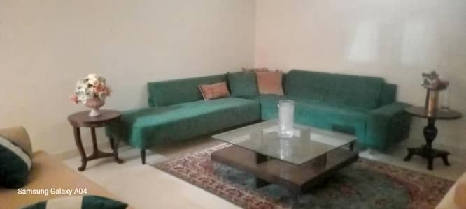 L shaped emerald green sofa beautiful color.