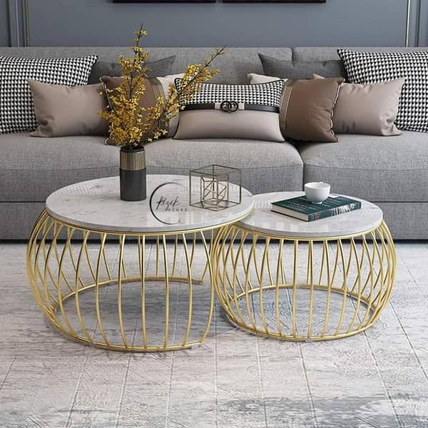 "Elegant round center table featuring a rich wooden base, a smooth marble top, and a sturdy metal frame, perfect for modern or classic interiors. "