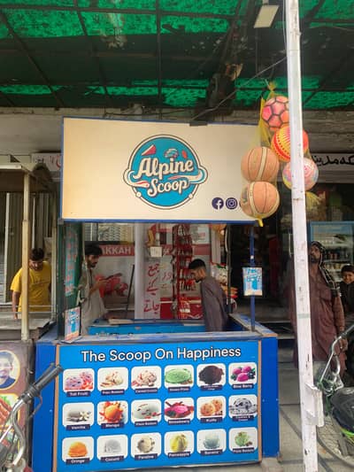 Complete ice cream setup for sale with freezer, counter, and stall.