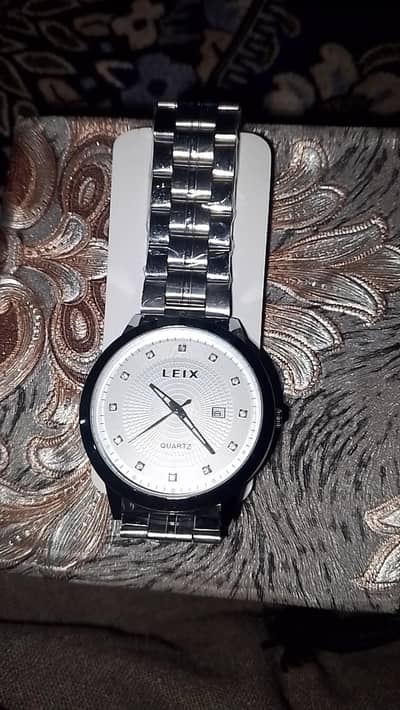 sliver watch with white dial