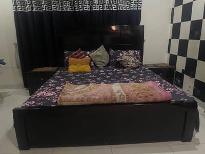 wooden bed with side drawers