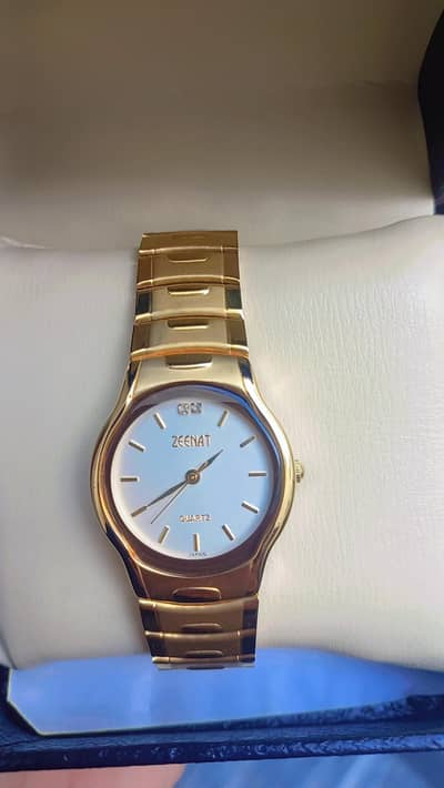 Zeenat MOD#K4033M gold-tone stainless steel analog wrist watch.