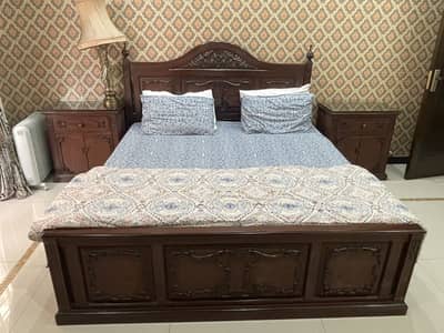Wooden bed with side tables
