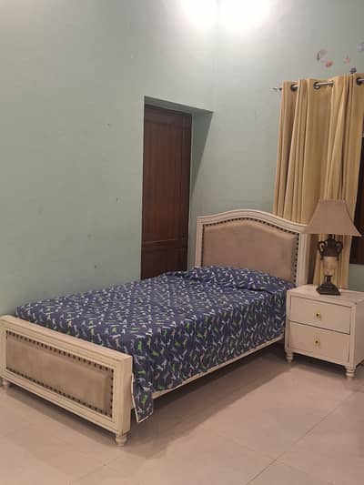 single beds with bedside tables