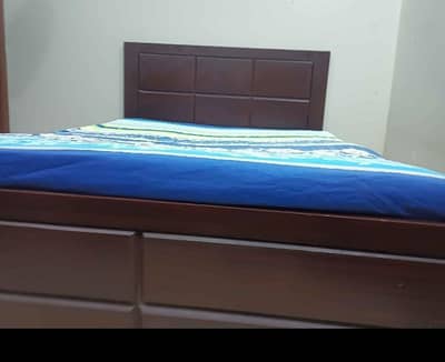 queen size bed with spring mattress and 1 side table