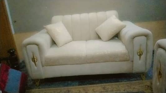 Elegant cream-color two seater sofa in very good condition. Comfortabl