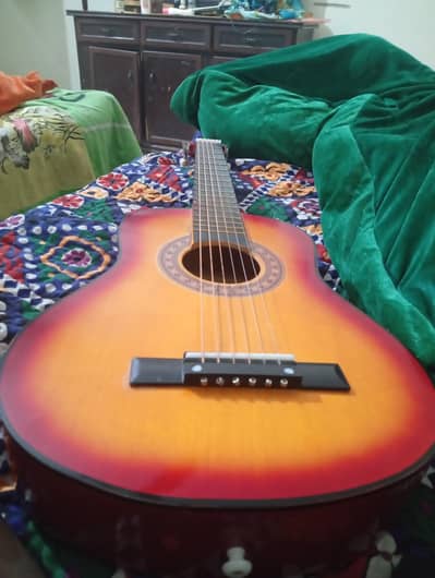 Guitar 32 inches with picks and 2 string just for 9500rs