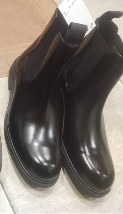 black leather Chelsea boots.