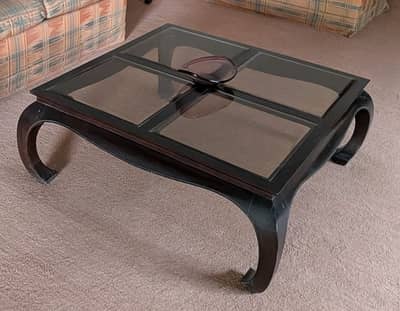 Beautiful dark wood coffee table with glass panes