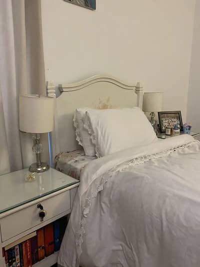 Bed with side tables and lamps